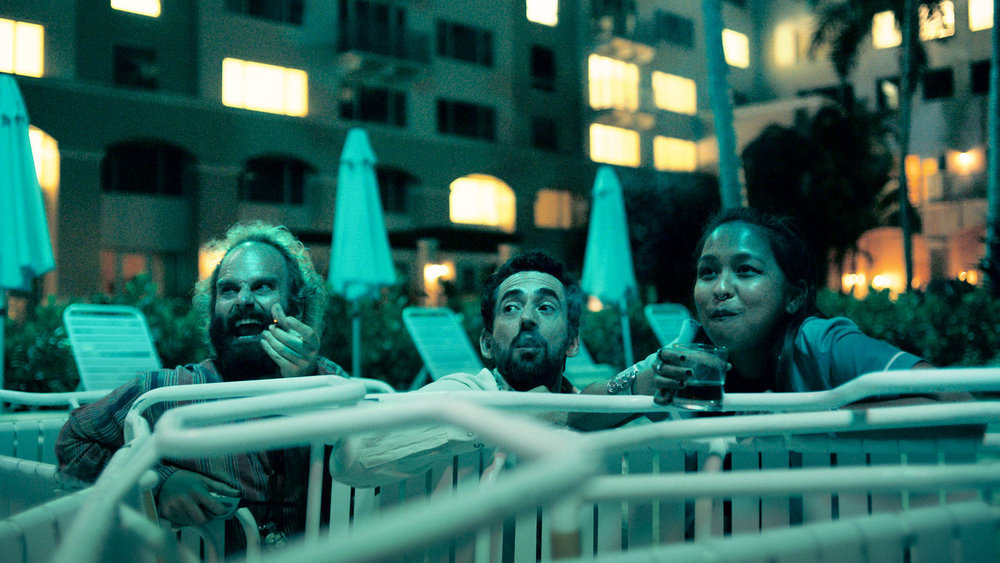 THE RESORT -- Episode 104 -- Pictured: (l-r) Ben Sinclair as Alex, Luis Gerardo Mendez as Baltasar, Gabriela Cartol as Luna -- (Photo by: Peacock)