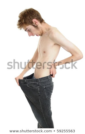 stock-photo-a-young-man-looking-down-at-his-old-pants-when-he-was-fat-looks-like-he-lost-some-weight-and-is-59255563.jpg