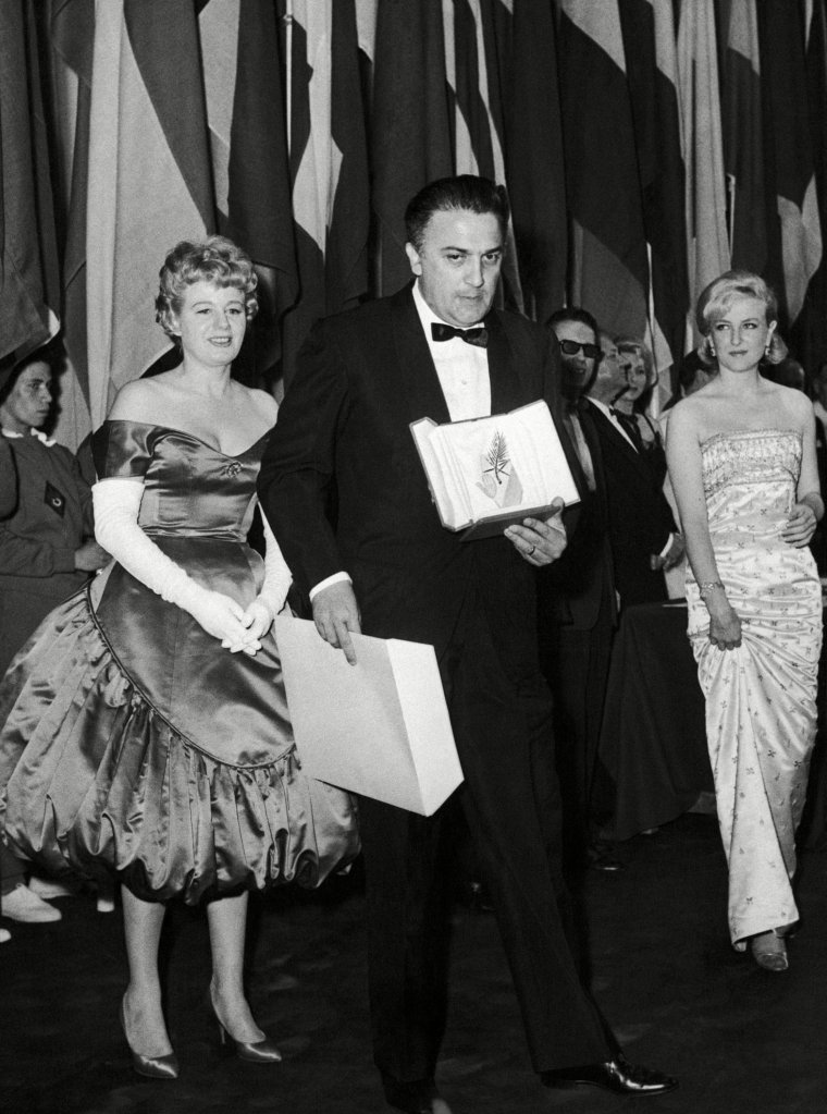 Prizes were awarded on at the Cannes Festival Palace for this 1960 Film Festival. The winning film of the festival is La Dolce Vita of Italian film director Frederico Fellini - after receiving his Palme d'Or award, here is Fellini leaving the stage as on each side follow on American actress Shelly Winter, left, and French actress Nicole Courcel, rightFrance Cannes Film Festival Federico Fellini, Cannes, France