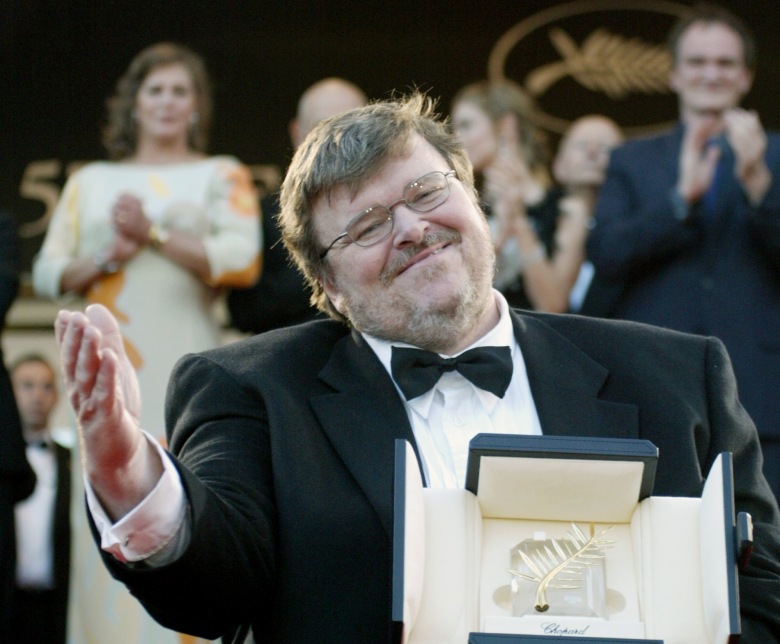 TARANTINO MOORE TURNER American film director Michael Moore gestures while presenting his Palme d'Or trophy for his documentary film Fahrenheit 9/11 as he climbs the steps of the festival palace during the closing ceremony of the 57th International Film Festival in Cannes, southern FranceFRANCE CANNES FILM, CANNES, France