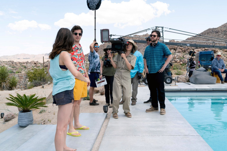 PALM SPRINGS, first two from left: Cristin Milioti, Andy Samberg; in blue shirt at center: director Max Barbakow, on set, 2020. ph: Jessica Perez / © Hulu / Courtesy Everett Collection