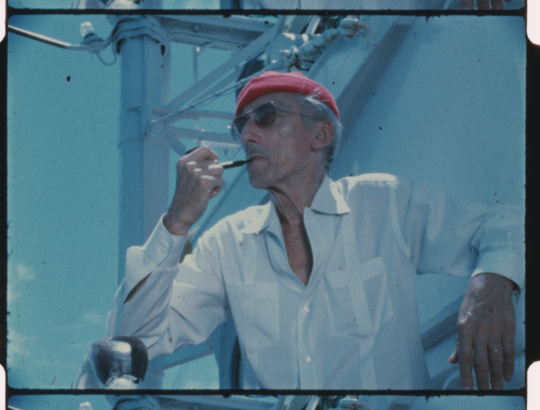 Jacques Cousteau wears his iconic red diving cap aboard his ship Calypso, circa 1970s. (Credit: The Cousteau Society)