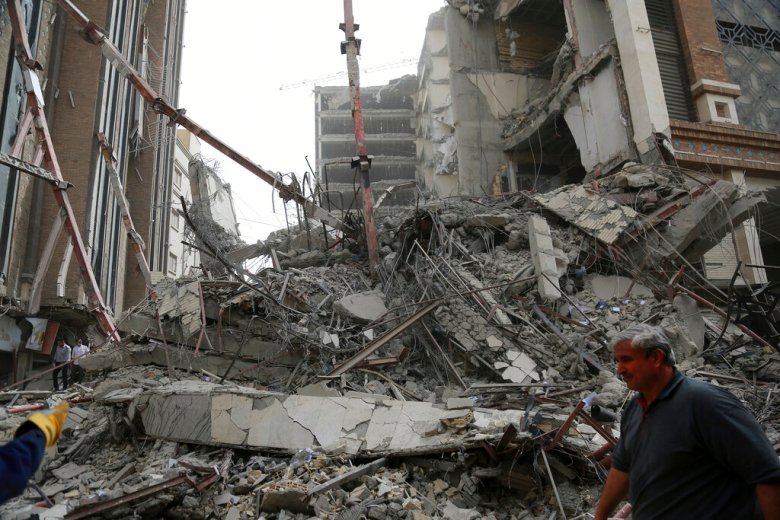 In this photo provided by Fars News Agency, rubble remains from a 10-story commercial building under construction that collapsed killing several people in the southwestern city of Abadan, Iran, Monday, May 23, 2022. There are fears the casualty toll could be much higher as more than 80 people were still believed to be trapped under the rubble after the Metropol building toppled, burying shops and even some cars in the surrounding streets, state TV reported. (Mohammad Amin Ansari, Fars News Agency via AP)