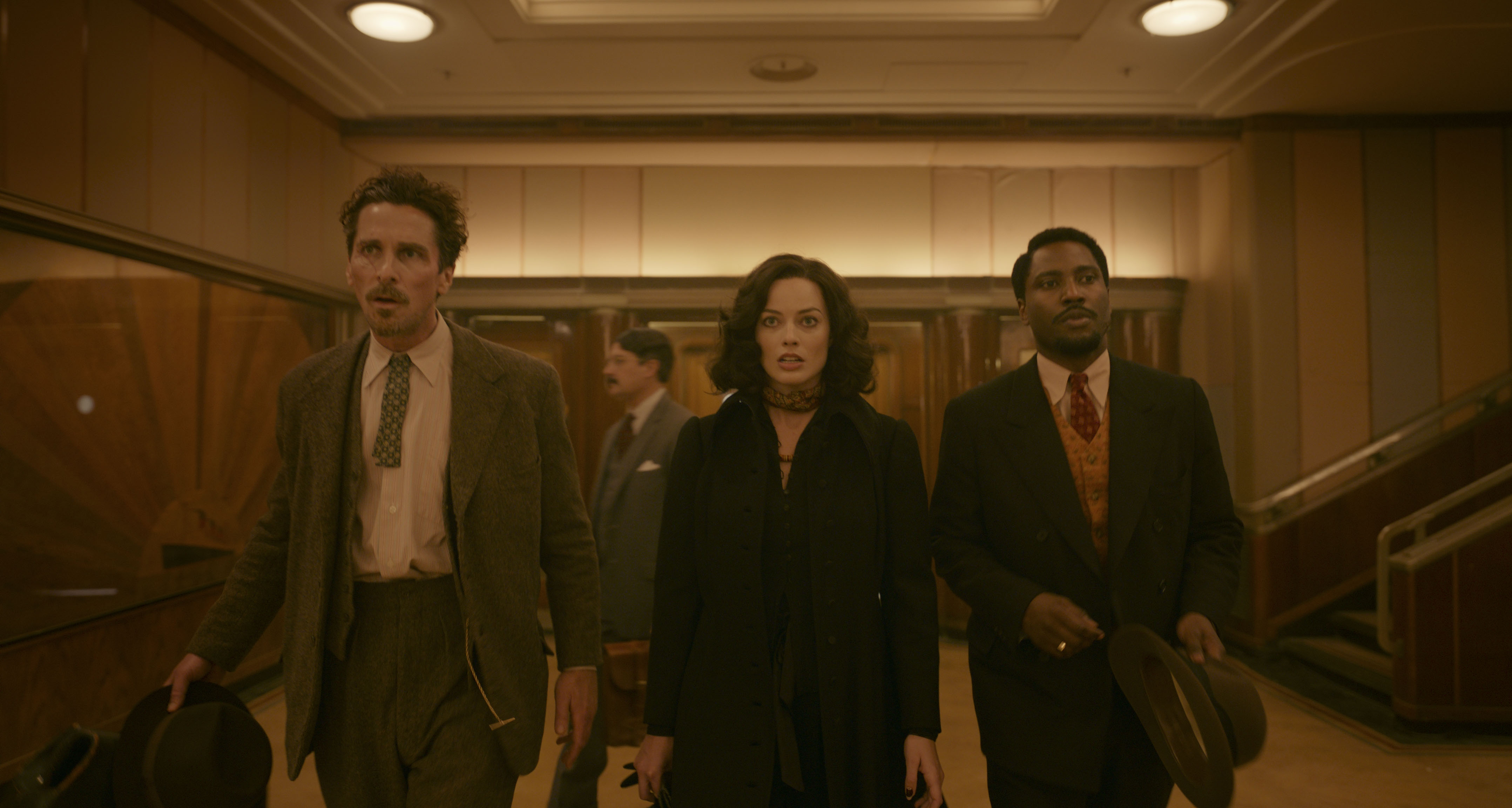 (L-R): Christian Bale, Margot Robbie, and John David Washington in 20th Century Studios' AMSTERDAM. Photo courtesy of 20th Century Studios. All Rights Reserved.