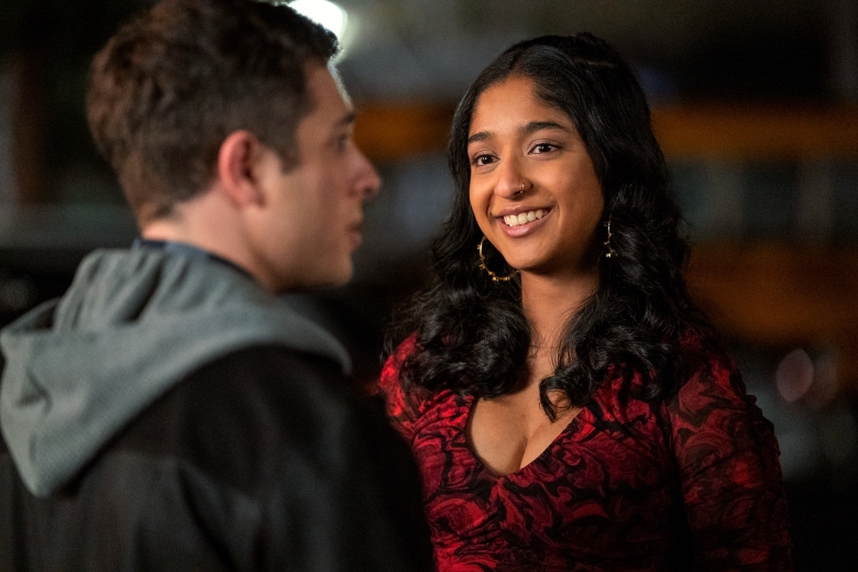 A teen girl in a red and black dress smiles adoringly at a boy in a gray hoodie; still from Never Have I Ever