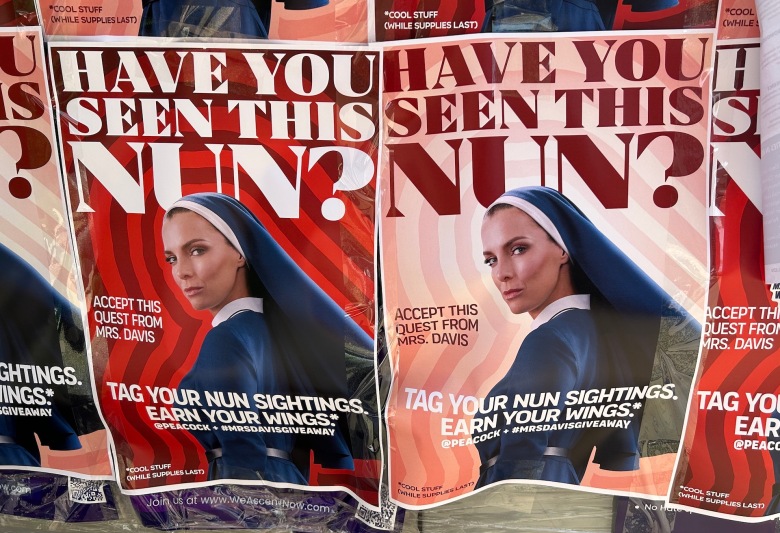 Flyers saying HAVE YOU SEEN THIS NUN? in big, bold text with a photo of actor Betty Gilpin in a blue nun habit to advertise Mrs. Davis