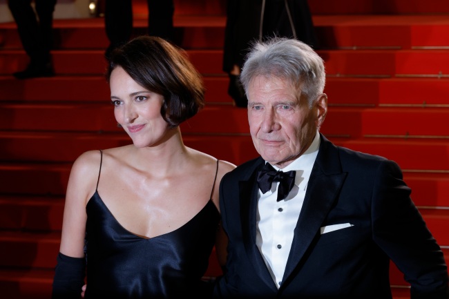 CANNES, FRANCE - MAY 18: Phoebe Waller-Bridge and Harrison Ford depart the Indiana Jones And The Dial Of Destiny red carpet during the 76th annual Cannes film festival at Palais des Festivals on May 18, 2023 in Cannes, France. (Photo by Mike Coppola/Getty Images)